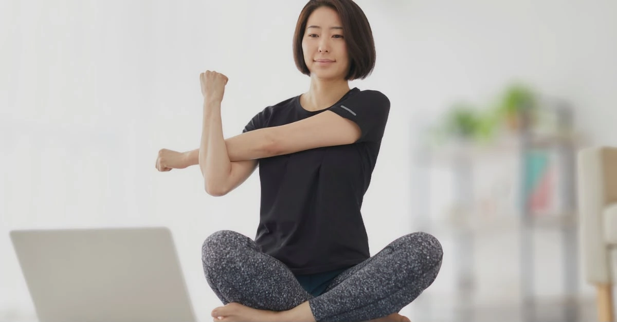 Woman performing an upper-body warm-up to avoid home workout mistakes