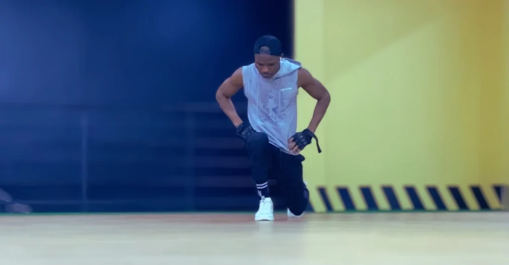 Anthony performing a walking lunge for lower-body strength