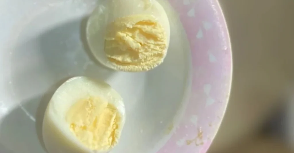 Anthony holding a bowl of diced eggs showing the yolk while discussing how much protein is in an egg